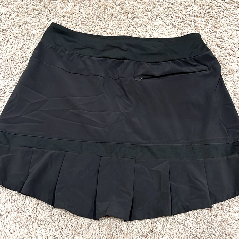 Women's black Nike Dri-fit golf skirt with built in compression shorts.